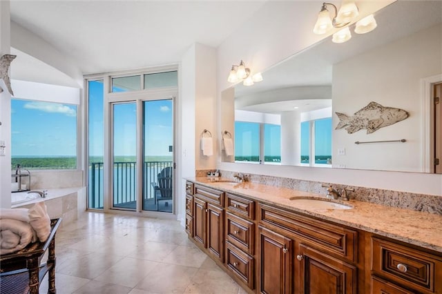 bathroom with double sink vanity, tile flooring, a relaxing tiled bath, and plenty of natural light