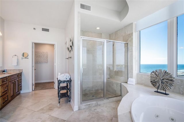 bathroom featuring vanity, tile floors, a shower with door, and a water view