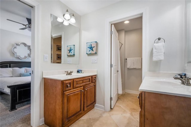bathroom featuring ceiling fan, tile flooring, double sink, and vanity with extensive cabinet space