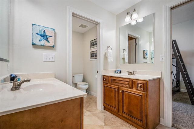 bathroom featuring tile floors, toilet, and vanity
