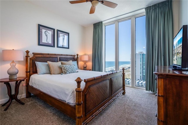 bedroom with a water view, carpet floors, access to exterior, and ceiling fan