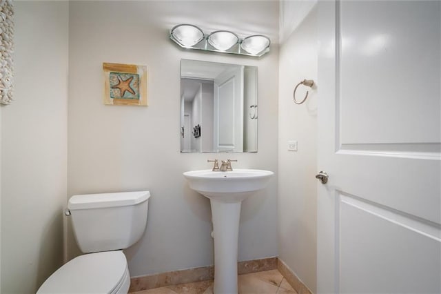 bathroom featuring tile floors and toilet