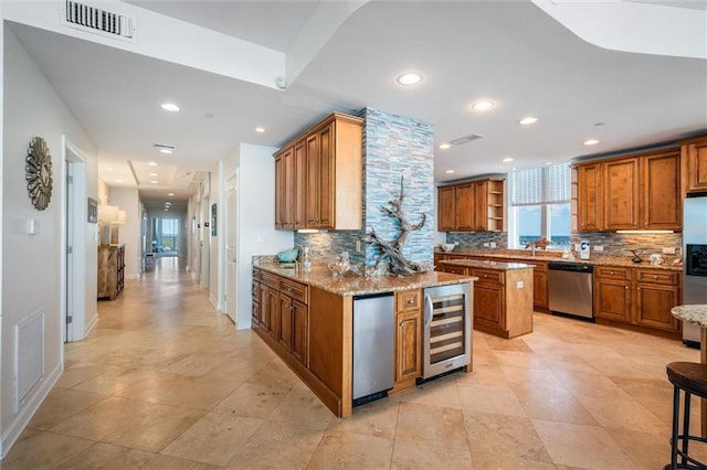 kitchen with light stone counters, light tile floors, stainless steel appliances, beverage cooler, and backsplash