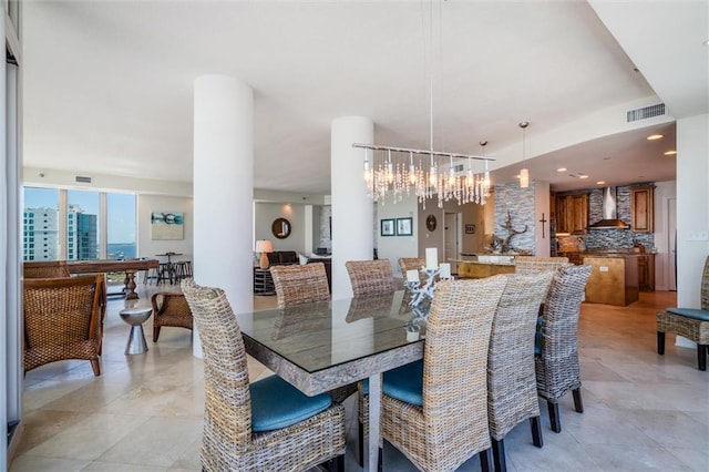 dining space with light tile floors and an inviting chandelier