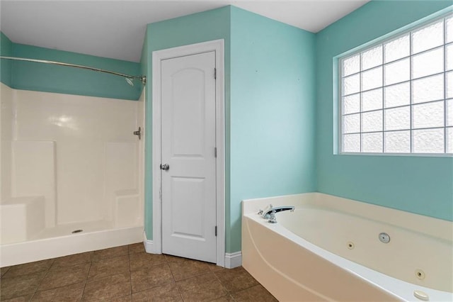 full bath featuring tile patterned floors, walk in shower, a tub with jets, and baseboards