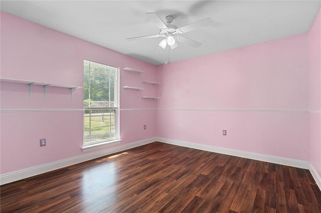 empty room featuring baseboards, ceiling fan, wood finished floors, and a healthy amount of sunlight