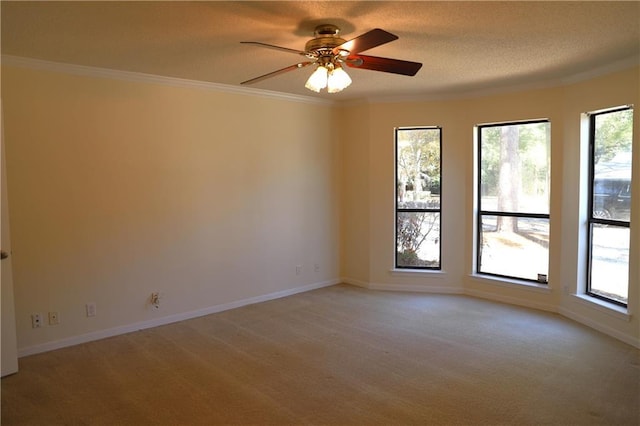 unfurnished room with crown molding, ceiling fan, light carpet, and a textured ceiling