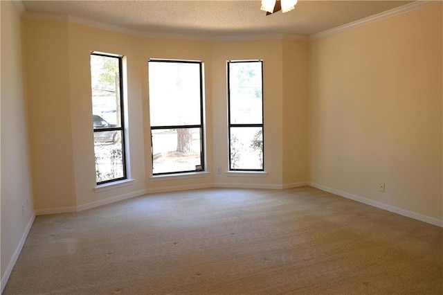 carpeted spare room with crown molding and a wealth of natural light