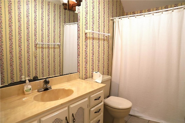 bathroom featuring vanity, tile patterned floors, and toilet