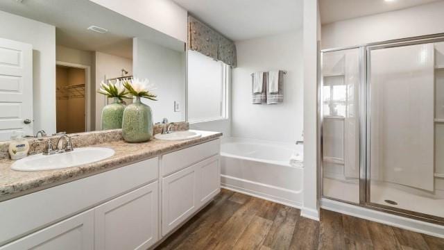 bathroom with vanity, wood-type flooring, and independent shower and bath