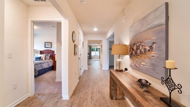 hallway with light hardwood / wood-style flooring