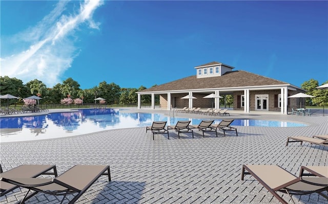 view of pool featuring an outbuilding and a patio area