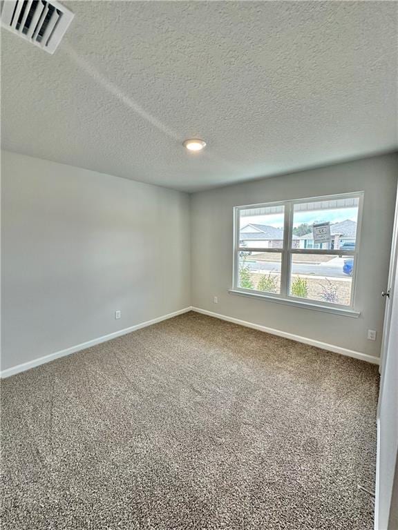 unfurnished room featuring carpet floors and a textured ceiling