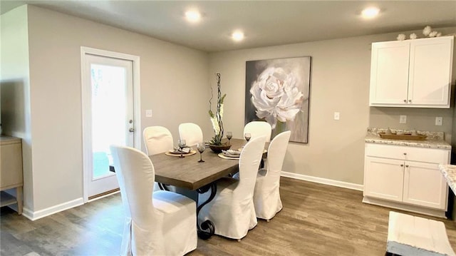 dining area with dark hardwood / wood-style flooring and sink