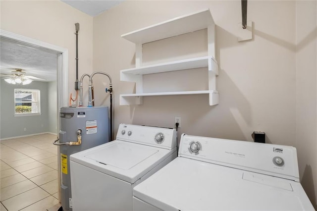 clothes washing area featuring light tile patterned floors, electric water heater, laundry area, a ceiling fan, and washing machine and clothes dryer