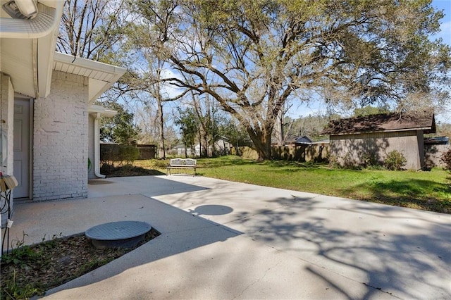 view of yard with fence and a patio