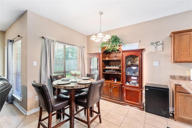 tiled dining room featuring a chandelier