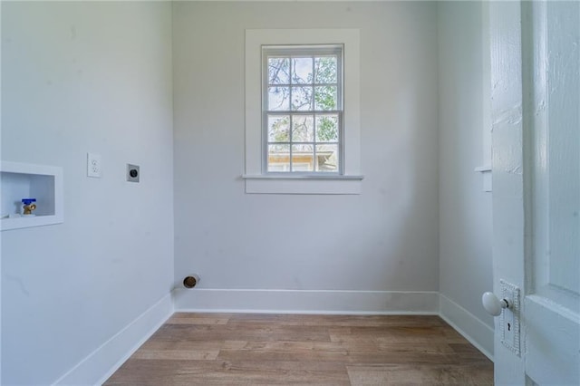 washroom with baseboards, washer hookup, laundry area, wood finished floors, and hookup for an electric dryer