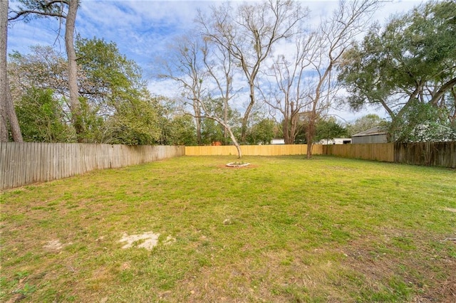 view of yard with a fenced backyard