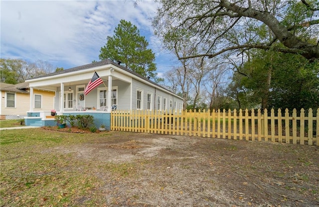 view of front of house with a fenced front yard and a porch