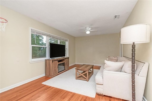 living room with hardwood / wood-style flooring and ceiling fan