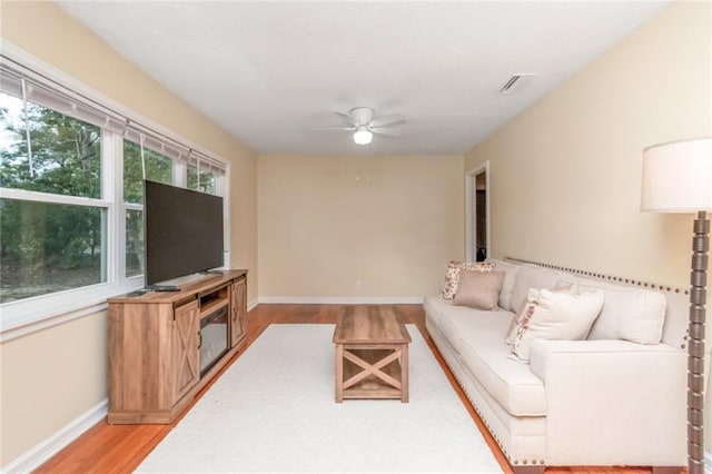 living room with hardwood / wood-style floors and ceiling fan