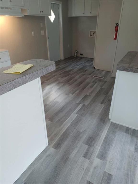 kitchen featuring dark wood-type flooring and white cabinets