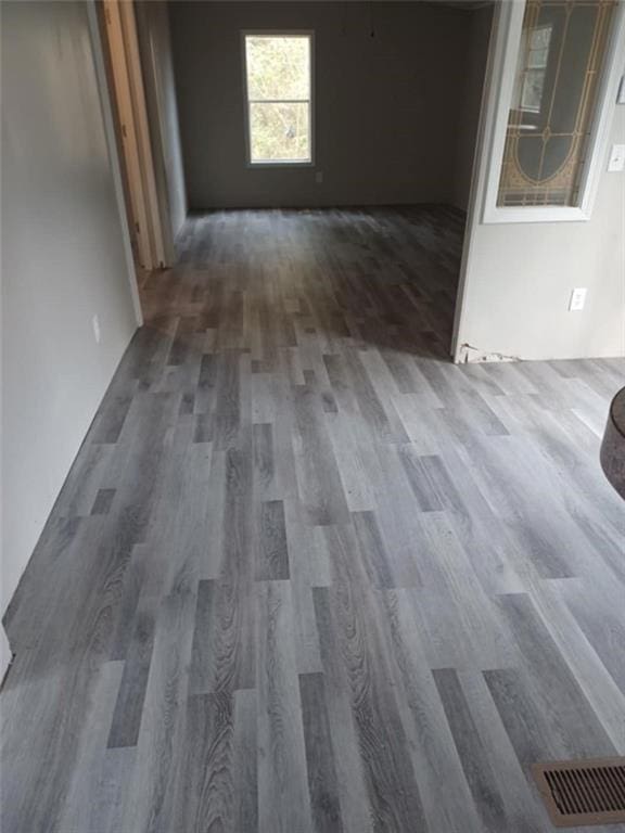 hallway with visible vents and dark wood finished floors