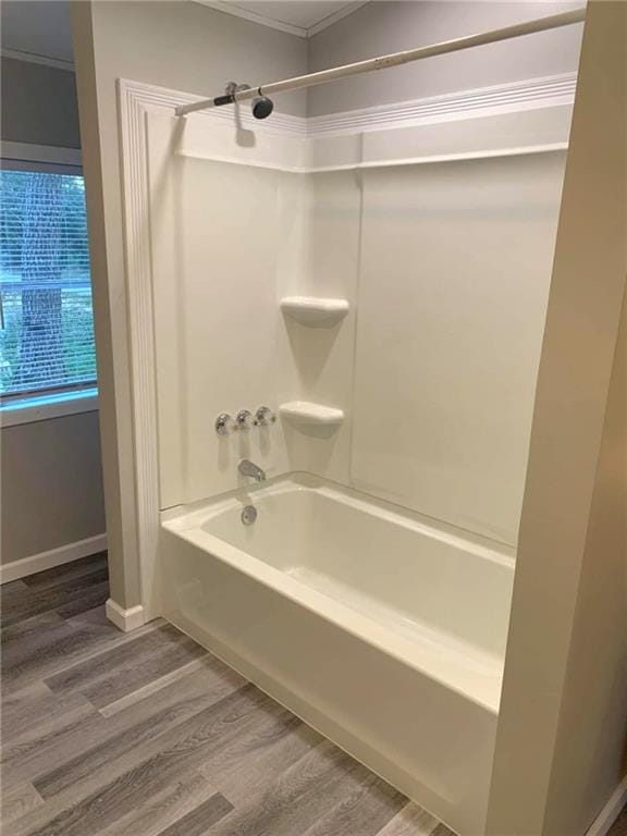 full bath featuring crown molding, shower / washtub combination, and wood finished floors