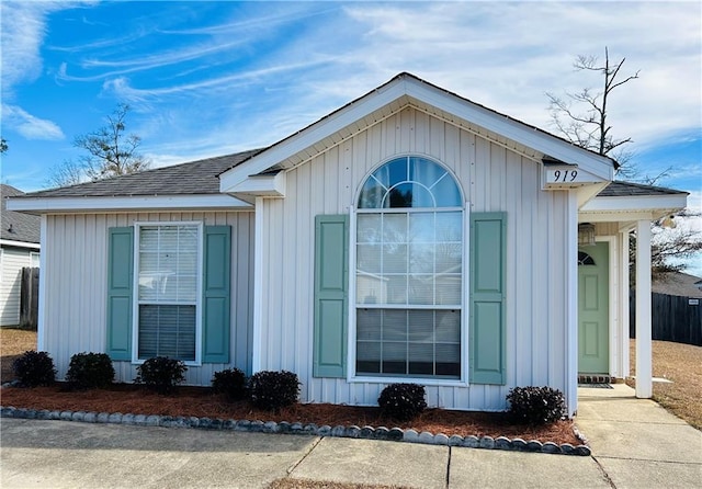 view of property exterior featuring board and batten siding and a shingled roof