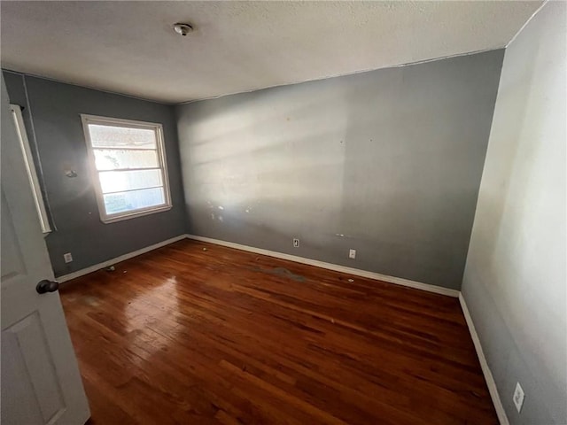 empty room with dark wood-type flooring