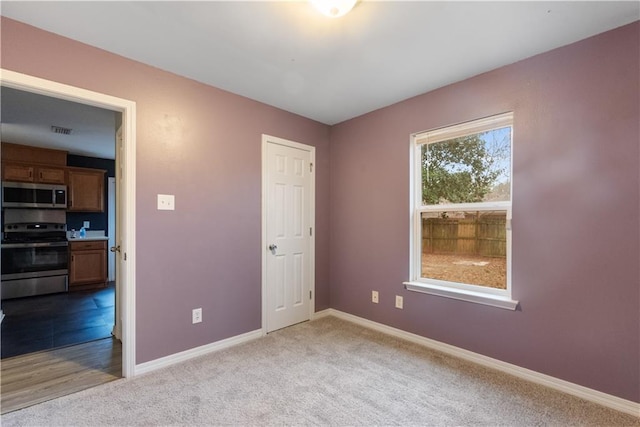 unfurnished bedroom with light carpet