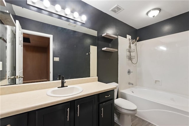 full bathroom featuring vanity, shower / bathing tub combination, and toilet