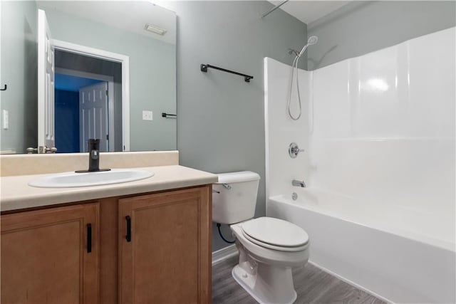 full bathroom featuring vanity, hardwood / wood-style flooring, shower / bathtub combination, and toilet