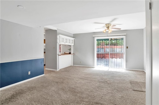 unfurnished living room featuring carpet floors and ceiling fan