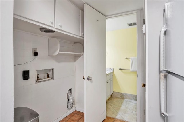 bathroom with tile patterned flooring and vanity