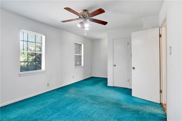 unfurnished bedroom featuring dark colored carpet and ceiling fan