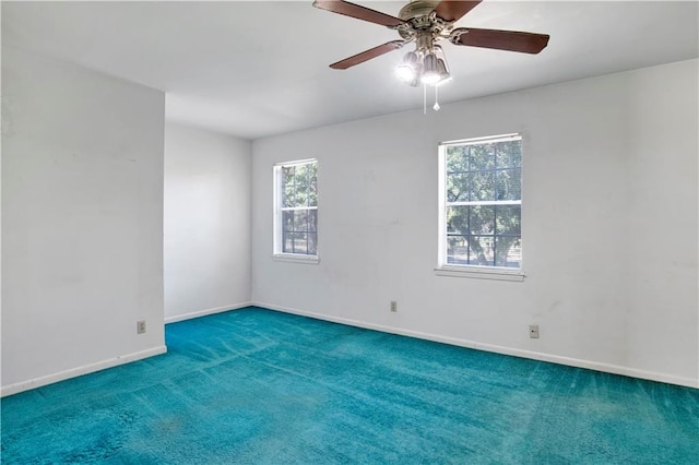 carpeted spare room featuring ceiling fan