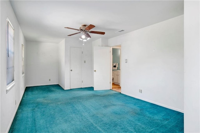 carpeted empty room with plenty of natural light and ceiling fan