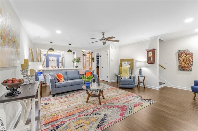 living room featuring sink, wood-type flooring, and ceiling fan