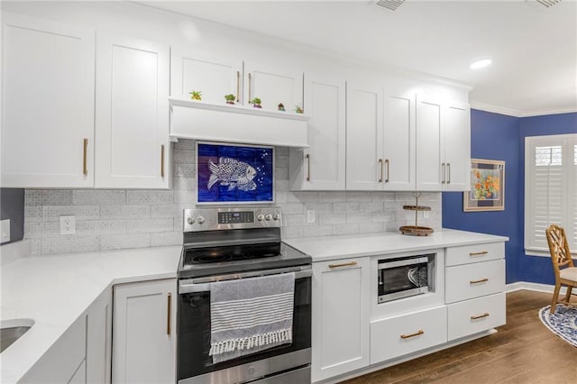 kitchen with crown molding, dark wood-type flooring, stainless steel appliances, and white cabinets