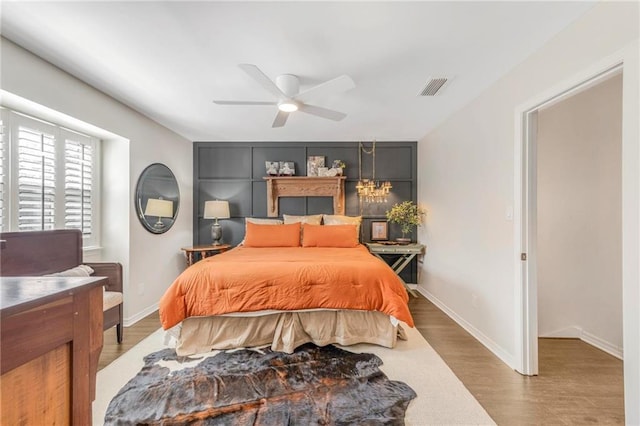 bedroom with hardwood / wood-style floors and ceiling fan