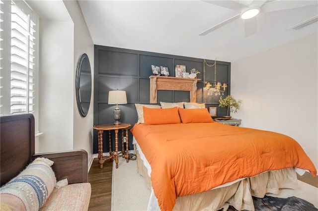 bedroom with wood-type flooring and ceiling fan