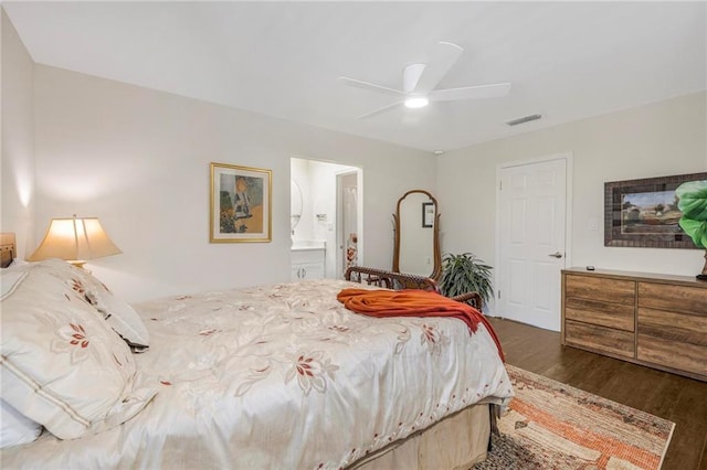 bedroom featuring dark hardwood / wood-style flooring, connected bathroom, and ceiling fan