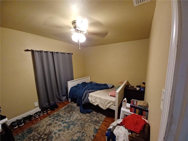 bedroom with dark wood-type flooring and ceiling fan