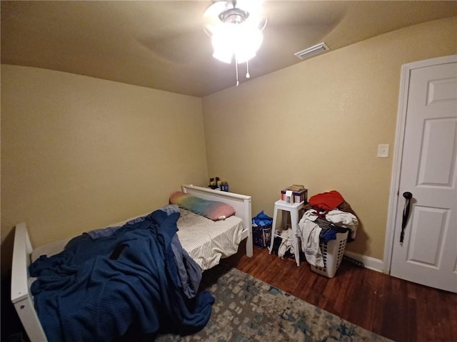 bedroom featuring ceiling fan and dark hardwood / wood-style floors