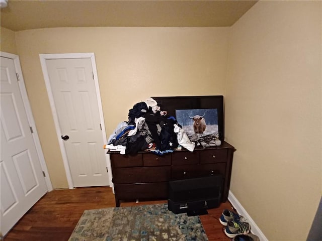 bedroom with dark hardwood / wood-style floors