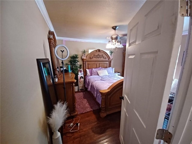 bedroom featuring ceiling fan, crown molding, and dark hardwood / wood-style flooring