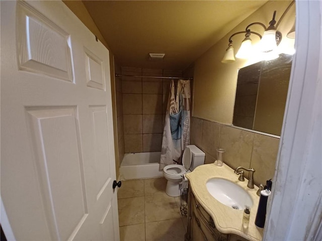 full bathroom featuring tile walls, tile patterned floors, vanity, toilet, and shower / tub combo with curtain