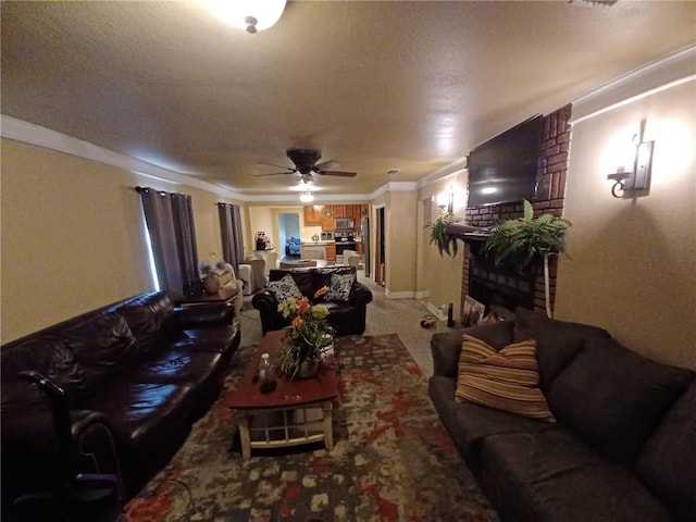 living room with ornamental molding, a fireplace, a textured ceiling, carpet flooring, and ceiling fan